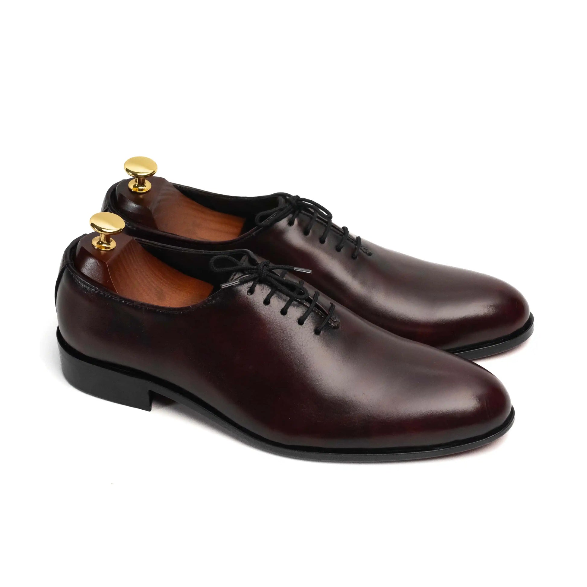 Crimson leather shoes paired with a formal outfit, demonstrating their versatility and stylish edge for modern men.