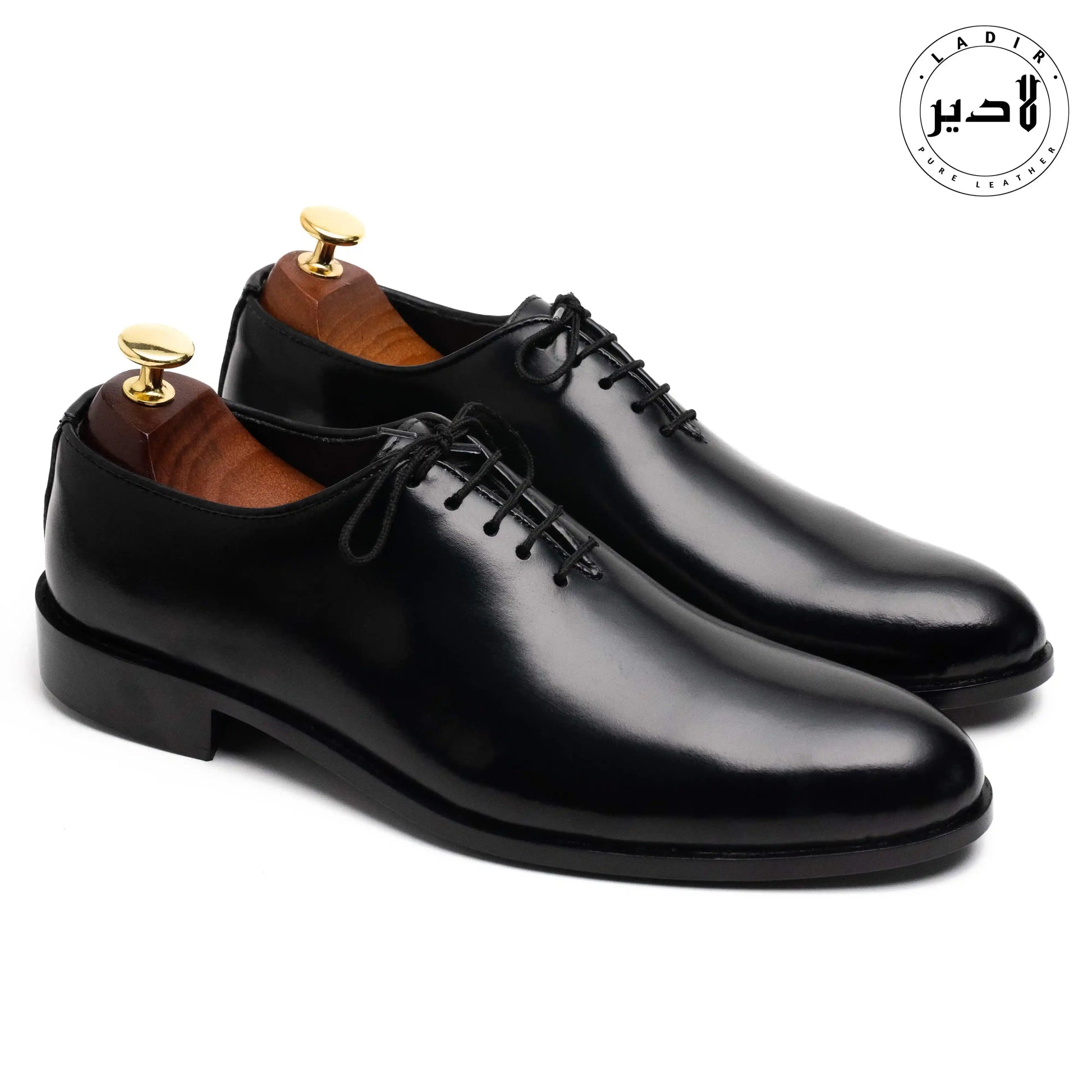 OXY BLACK leather shoes paired with a suit, illustrating their versatility and style for business meetings or formal events.
